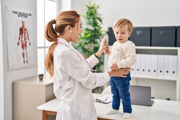 Mother and son having pediatrician consultation and playing at clinic