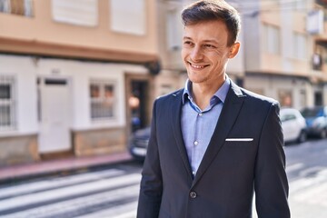 Young man business worker smiling confident standing at street