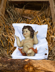Lourdes, France - January 1, 2022: Figurine of a newborn Jesus in Christmas cribs - nativity scene - in Lourdes