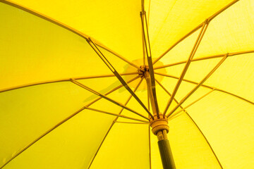 yellow umbrella with wooden umbrella take pictures from the inside