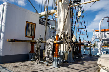 Wooden deck of an old sail ship, sailboat rigging.