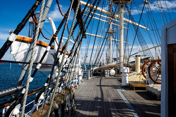 Wooden deck of an old sail ship, sailboat rigging.