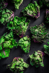 Kalette, kale sprouts, flower sprouts on black background. Heathy winter vegetable.