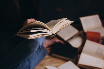 Close up of hands holding an old book.