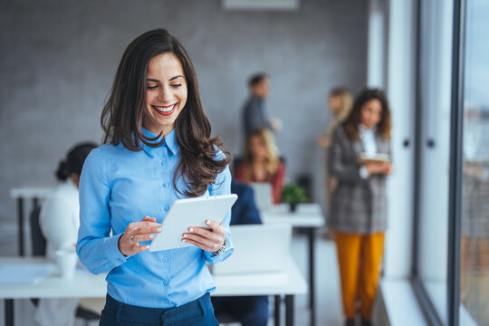 Urban happy business woman using tablet computer and working. Happy businesswoman using a digital tablet. Young leading businesswoman using a wireless tablet. 