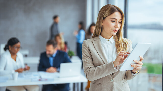 Urban happy business woman using tablet computer and working. Happy businesswoman using a digital tablet. Young leading businesswoman using a wireless tablet. 