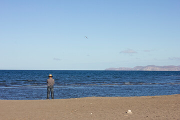 Man at the beach in front of the ocean