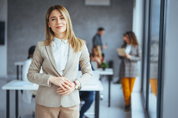 Shot of a confident young businesswoman standing in a modern office. Portrait of a businesswoman standing in the office. One Happy Pretty Business Woman Standing in office - Powered by Adobe