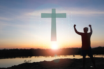 A man raises her hands and cross  with sunset.She is so calm hope,respect,spiritual ,...