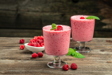 Yogurt smoothie with raspberries in glass on wooden table. weight loss concept. banner, menu, recipe place for text, top view