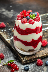 Scottish dessert whipped cream, roasted oatmeal and raspberries in jar. banner, menu, recipe place for text, top view