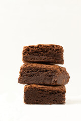 Pile of delicious brownies on white background.