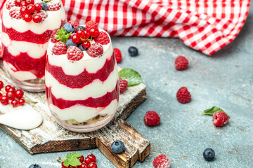 Scottish dessert whipped cream, roasted oatmeal and raspberries in jar. banner, menu, recipe place for text, top view
