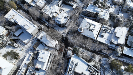 Aerial drone photo of main commercial centre of Kifisia district covered in snow during winter...