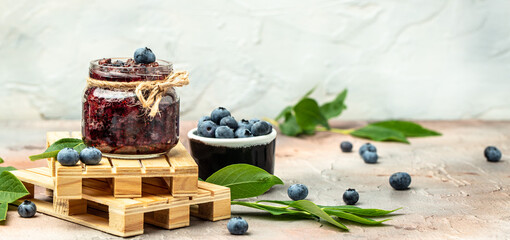 Blueberry jam or marmelade in glass. Blueberries fruits. place for text, top view