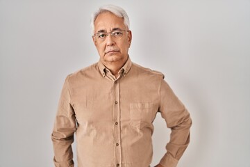 Hispanic senior man wearing glasses skeptic and nervous, frowning upset because of problem. negative person.