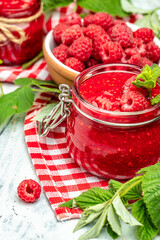 homemade raspberry jam or confiture on light background. vertical image. top view. place for text