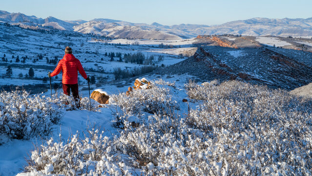 hiker in winter scenery of Rocky Mountains foothills in northern Colorado, Lory State Park