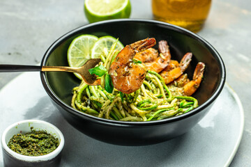 Zucchini raw pasta with pesto sauce and grilled shrimp cheese Parmesan, Restaurant menu, dieting, cookbook recipe top view