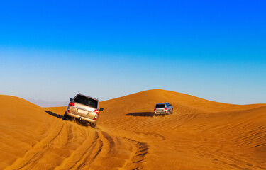 Offroad safari in sand desert, Empty Quarter Desert in United Arab Emirates. Offroaders on dunes in Rub’ al Khali desert. Sand and sky. © Sergo