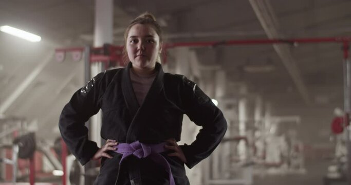 Female fighter with hands on waist