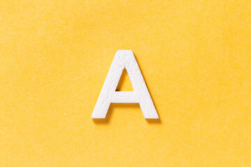Letter A of the alphabet isolated on yellow background, top view