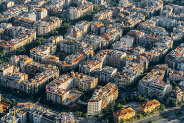 Fototapeta na wymiar Aerial view of typical buildings of Barcelona cityscape from helicopter. top view, Eixample residencial famous urban grid