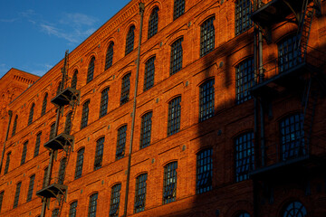 Red brick facade of the factory.