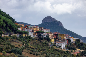 Fototapeta na wymiar Small Touristic Town, Baunei, in the Mountains of Sardinia, Italy. Cloudy Rainy Day. Fall Season