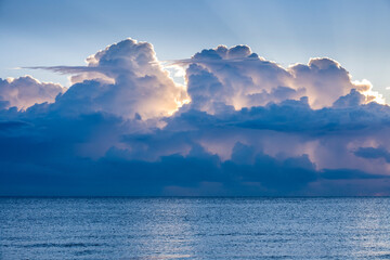 Clouds above calm ocean at sunrise