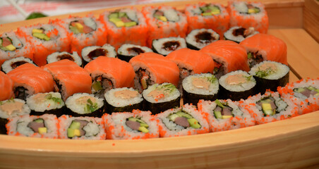 Juicy holiday sushi on a wooden plate