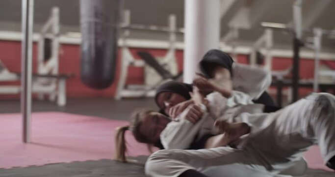 Woman performing chokehold on Muslim opponent