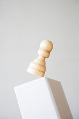 Pawn balancing on pedestal