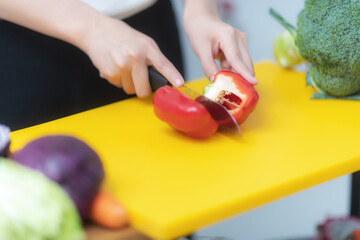 Woman hands cutting vegetables in the kitchen
