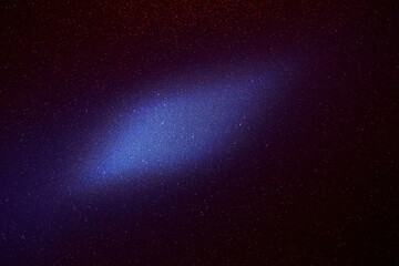 Obraz premium On a dark blue fine-grained background, a light blue cloud of light 