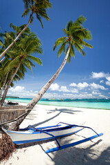 Obraz na płótnie Canvas Pristine beach with palm trees, white sand and turquoise tropical sea. Travel destination
