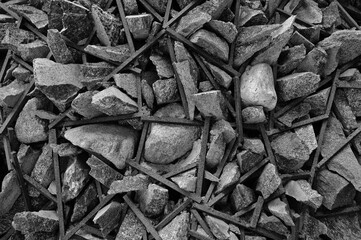 gray background, the photo shows gray stones and metal rod close-up