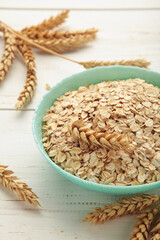 Oatmeal in bowl on white background. Healthy eating concept.