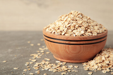 Oatmeal in bowl on grey concrete background