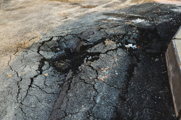Asphalt swelling close-up. Pothole and pit on road