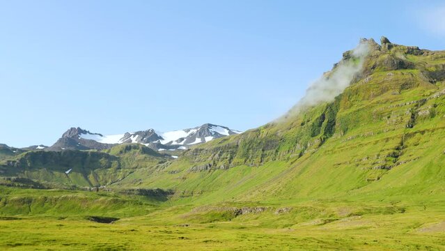 Icelandic green nature around Kirkjufell mountain in the snaefellsnes peninsula, during summer. High quality 4k footage