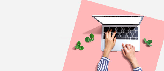 Laptop computer with shamrock leaves - flat lay