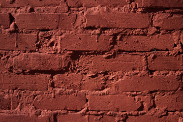 Textured red color brick wall background closeup