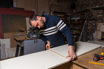 A carpenter works in a furniture workshop