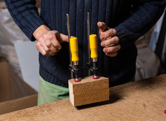 A carpenter works in a furniture workshop
