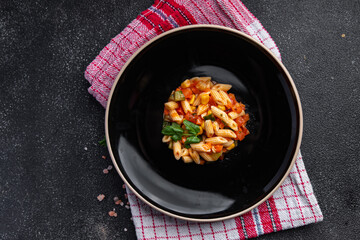 pasta salad tomato, cucumber, corn, vegetable, penne pasta meal food snack on the table copy space food background rustic top view 