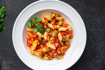 pasta salad tomato, cucumber, corn, vegetable, penne pasta meal food snack on the table copy space food background rustic top view 