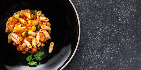 pasta salad tomato, cucumber, corn, vegetable, penne pasta meal food snack on the table copy space food background rustic top view 