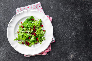 pomegranate salad green leaves, pomegranate seed,  lettuce mix healthy meal food snack on the table copy space food background rustic top view 