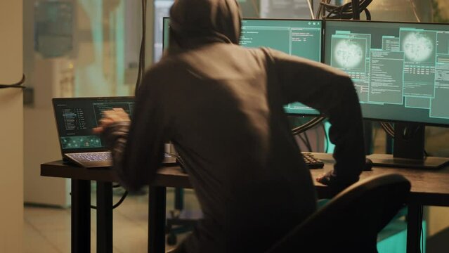 Professional web thief using malware to access system and steal sensitive information. Hacker doing phishing and planting virus to create security breach, hacktivism and cryptojacking.